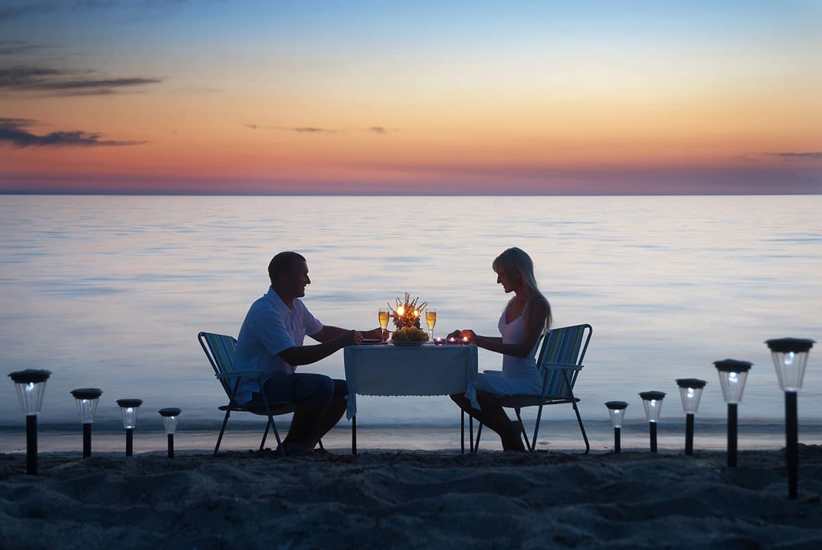 Couple having dinner on the beach
